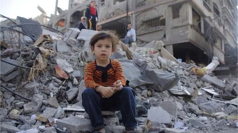 Photo de fillette Gazaoui, assise sur tas de ruines en novembre 2023.
